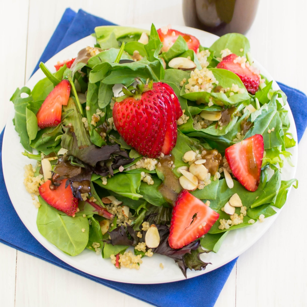 Strawberry Quinoa Salad...a nutritious combination of baby greens, quinoa, fresh sliced strawberries, sliced almonds and topped with Balsamic Vinaigrette
