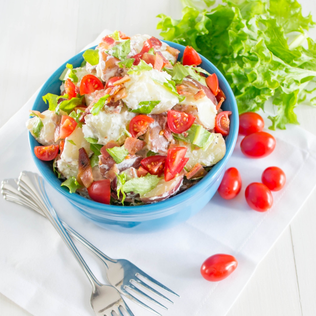 This BLT Potato Salad is so delicious! It is a combination of creamy red potatoes, crisp bacon, sweet tomatoes, and garden fresh lettuce.  | Pick Fresh Foods